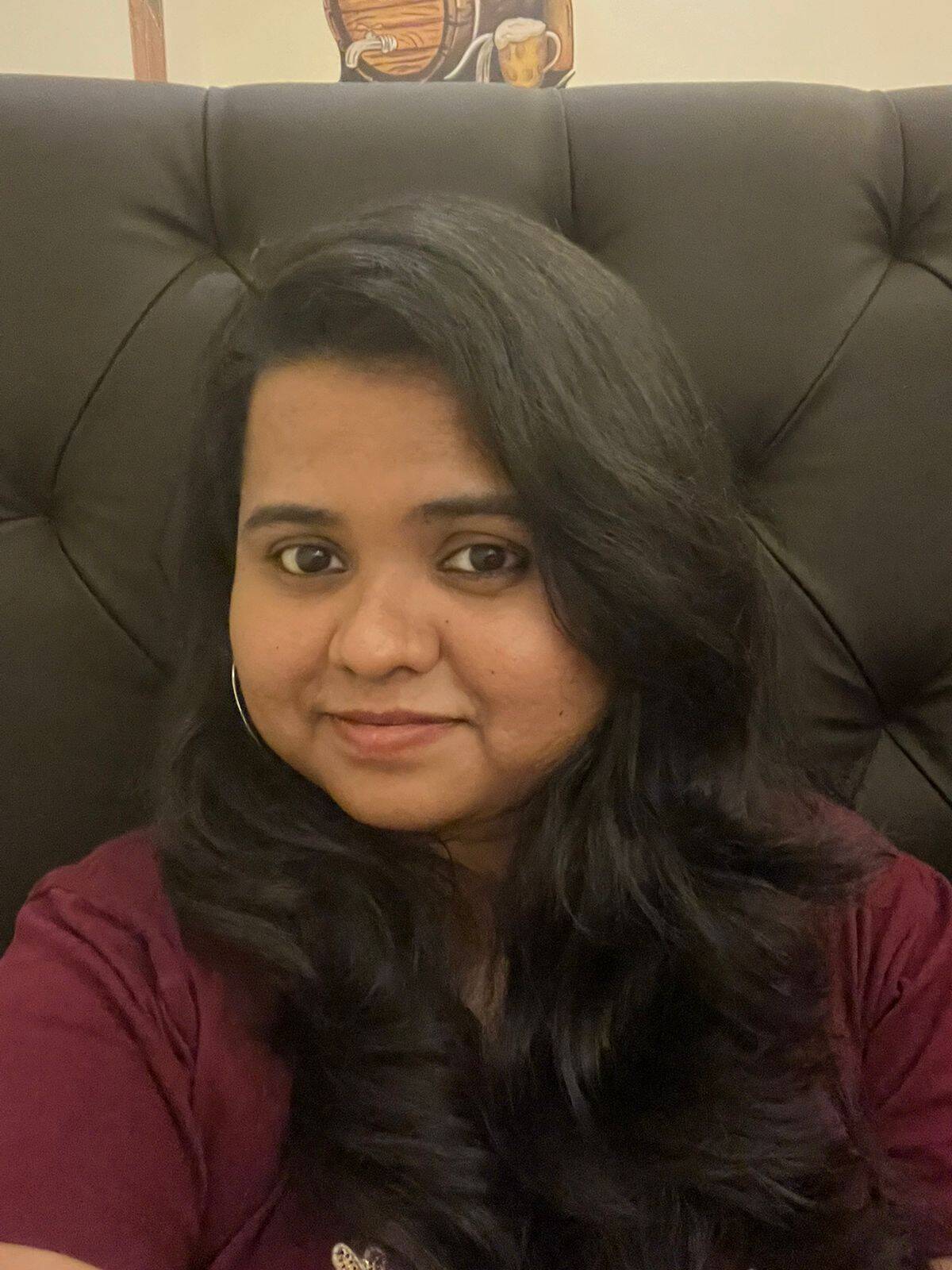 Portrait of a woman at Charwaha restaurant, showcasing authentic Indian cuisine.